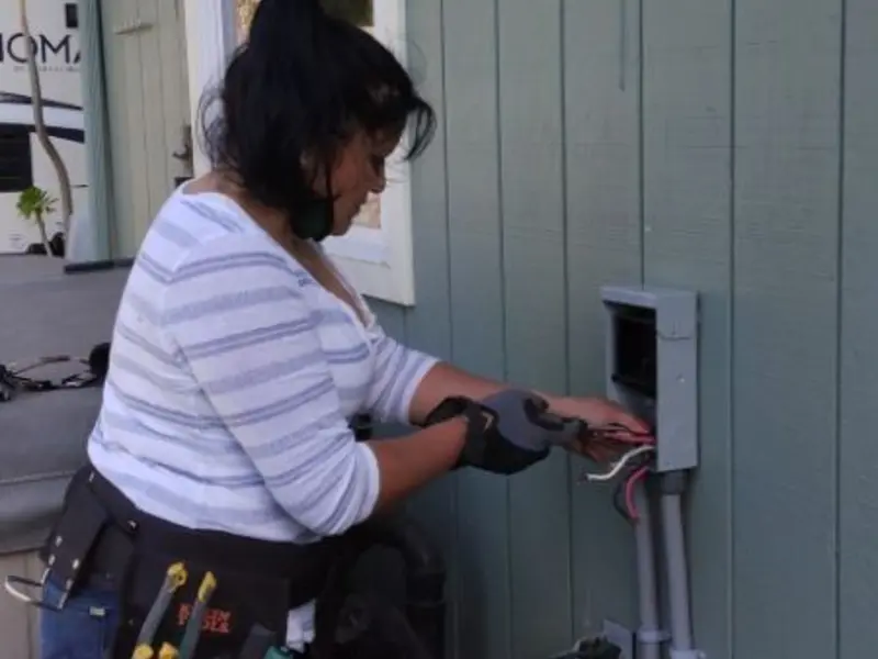 Licensed electrician wiring an exterior subpanel in Villas