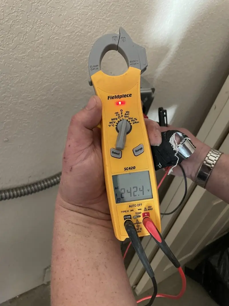 Voltage testing with clamp meter during Ceiling Fan Installation in Villas